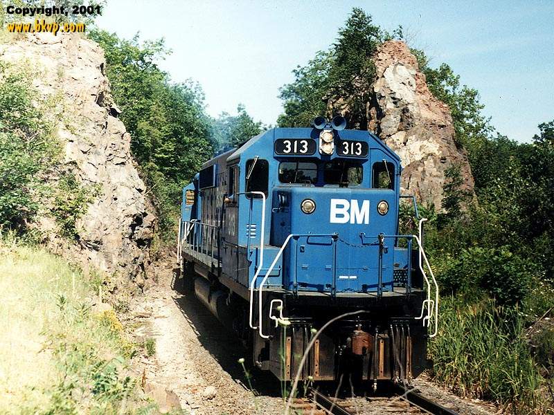 Photo of Boston & Maine train through the rock cut, out of E. Deerfield Yard.