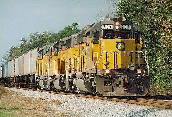 Photo of FEC SD40-2 #704 leads T#101 south at Sunbeam, FL.