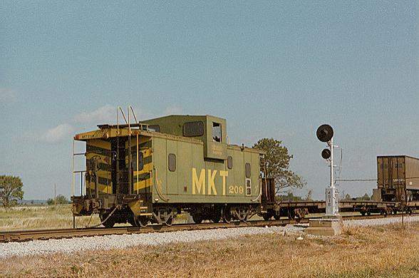 Photo of MKT Caboose #209 on northbound freight at Adair, OK.