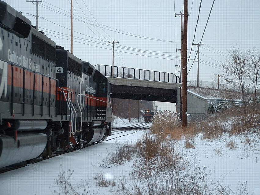 Photo of Eastbound Crawls into Lawrence Yard while BAED makes track speed on the Main.
