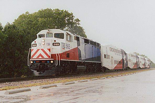 Photo of F59PH #565 leads train #2936 thru a rainstorm at Irving, TX.