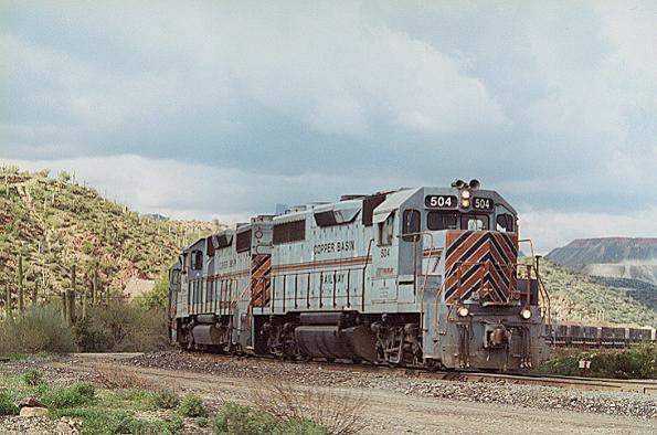 Photo of CB GP39 #504 leads a loaded ore train from the mines at Ray, AZ.