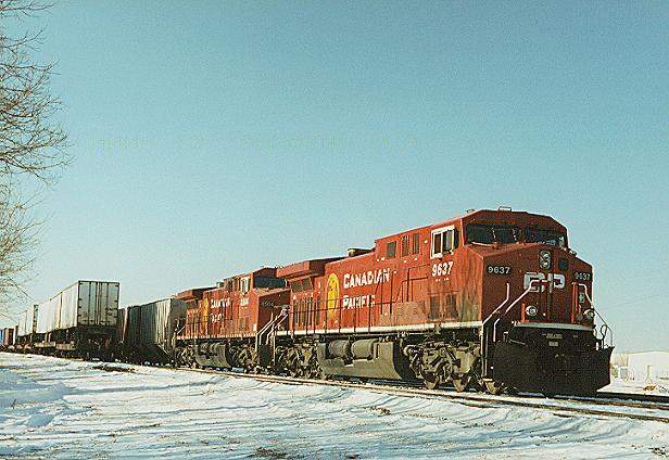 Photo of AC4400-CW's #9637 & 8504 pass a wb freight at Humboldt Yd, Minneapolis, MN.