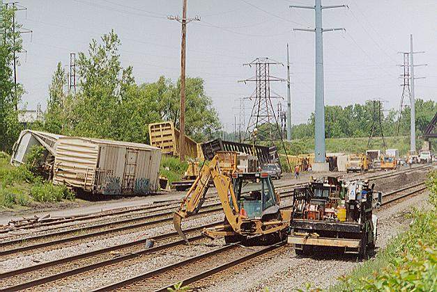 Photo of Crews work to restore the 3 mainline tracks and 1 yard runner.