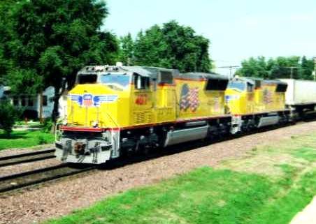 Photo of Union Pacific wings and flags lash up head west at Rochelle, IL.