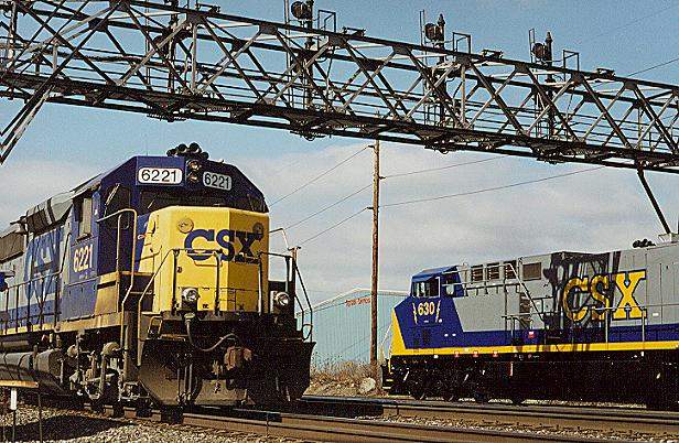 Photo of GP40-2 #6221 leads an eastbound past stopped AC6000-CW #630 & 629.