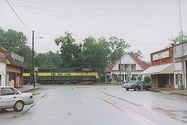Photo of Bay Line GP38-2 #510 heads east through downtown Newville, AL.