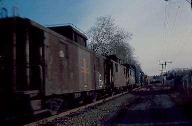 Photo of B&M train NY-20 heading east with three buggies at the rear.