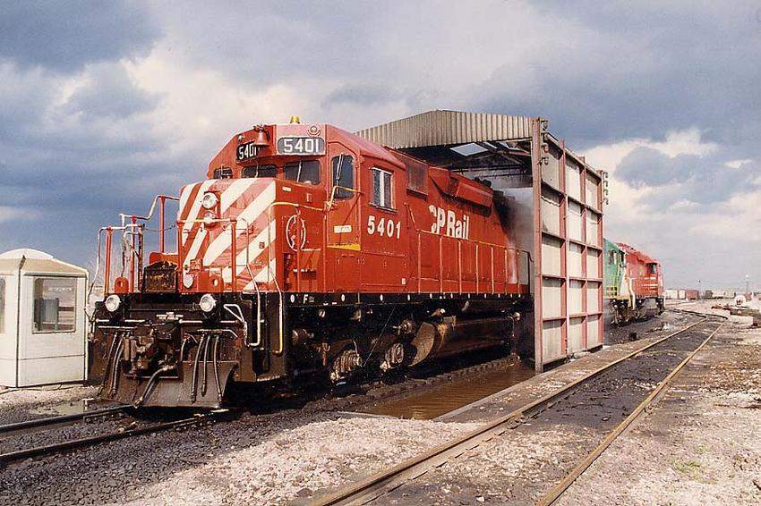 Photo of CP Rail SD40-2 and sisters get a bath.