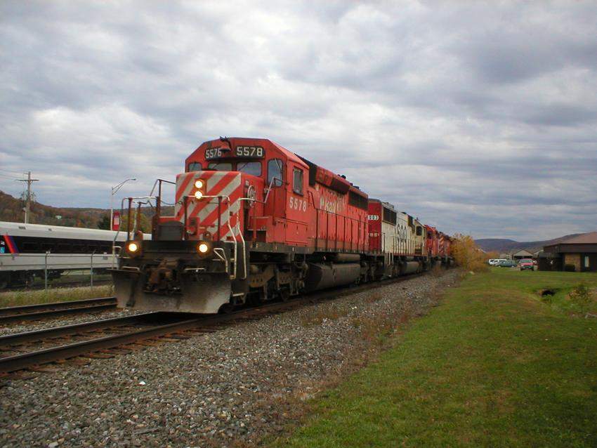 Photo of NS/CP train crawling past the Alstom railcar building facility.