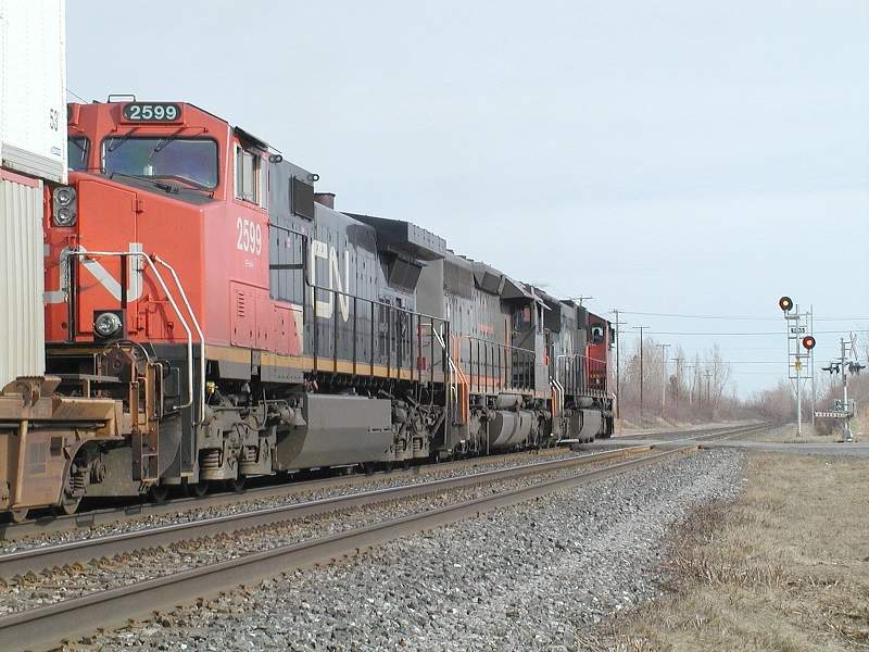 Photo of CN 148 roars eastbound at St Hilaire,Que,