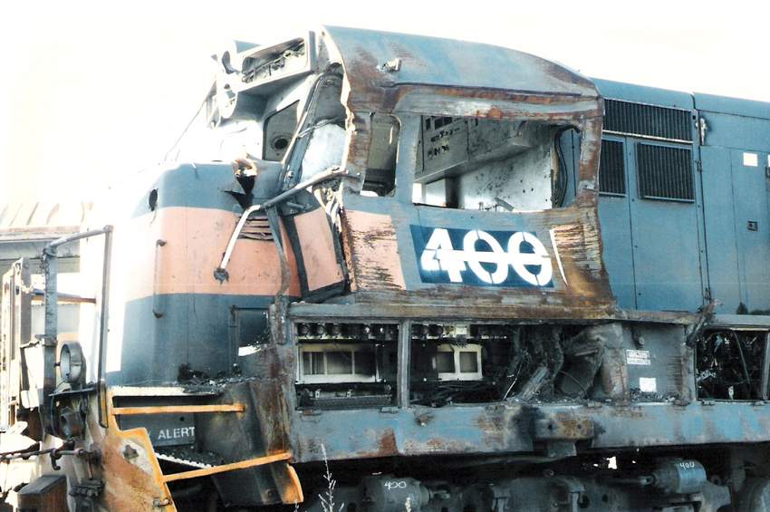 Photo of Closeup of wrecked MEC #400 (ex-#406) whitelined behind Waterville backshop