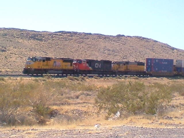 Photo of Eastbound UP stack train w/CN loco in consist. East of Las Vegas, NV.