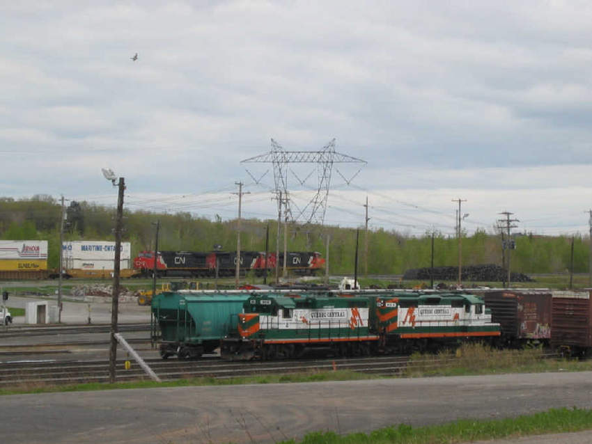 Photo of Two locomotives pull a Quebec Central train in the Joffre yard