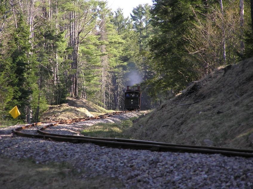 Photo of Train rounding the curve to collect the work crew at the end of the day.