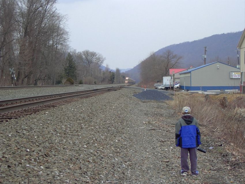Photo of A very patient railfan waits for NS 11n to pass cp cove