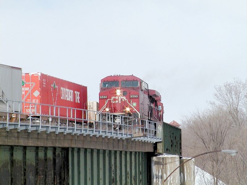 Photo of CP 9590 leads a detour train over CN's victoria bridge into Montreal.
