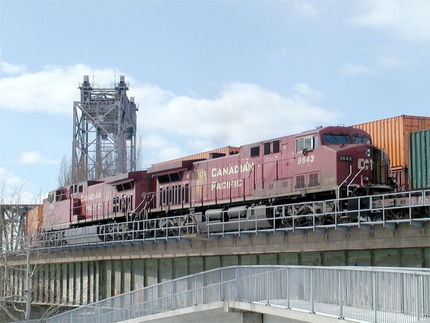 Photo of CP 9590 leads a detour train over CN's victoria bridge into Montreal.