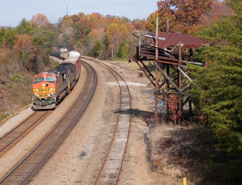 Photo of NS 167, with BNSF 4409 in the lead, passes an old watering facility at Winfield.