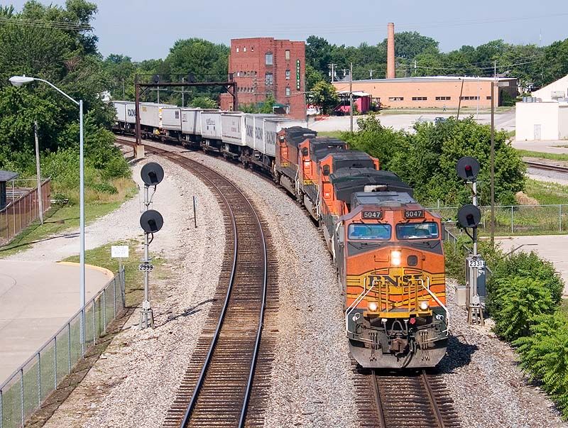 Photo of BNSF 5047 leads a stack train out of Fort Madison, Iowa.