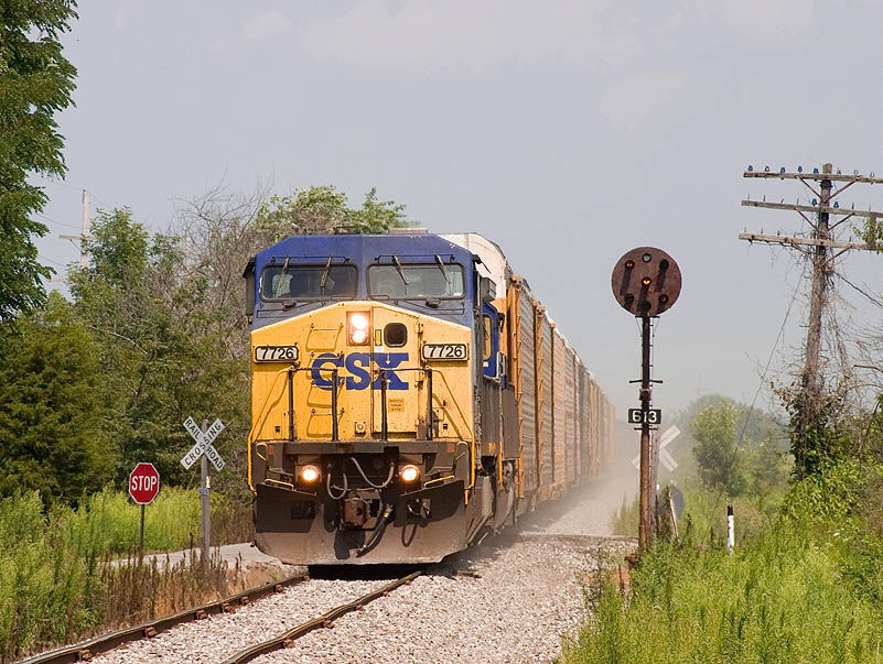 Photo of CSX 7726 leads CSX train Q243 through Farmington, IN.