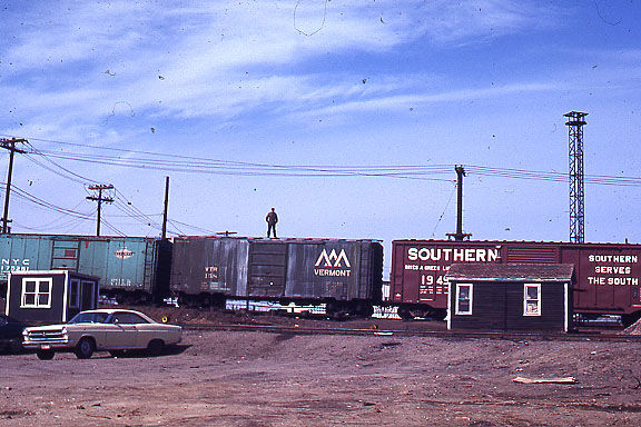 Photo of Brakeman on Top of Boxcar - Mystic Junction