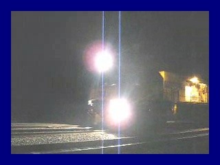 Photo of The Loram RailGrinder Moving Thru the Night