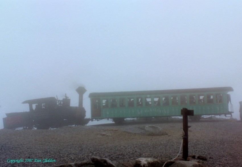 Photo of The Cog Railway arrives at the top of Mt. Washington in the clouds.