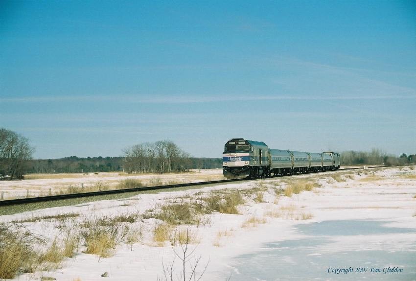 Photo of Downeaster #684 speeds through the marsh in Scarborough.