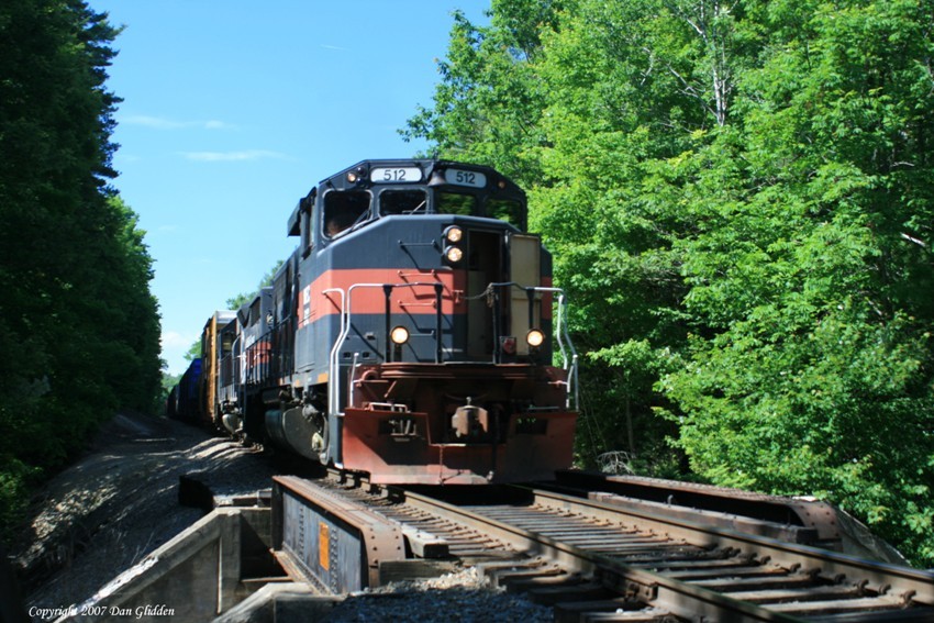 Photo of MEC 512 crossing a small bridge in New Gloucester