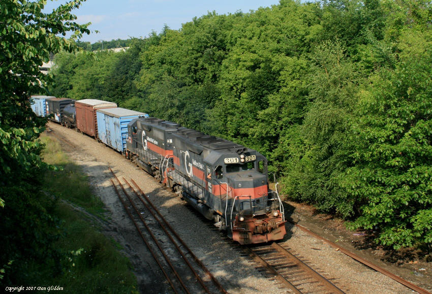 Photo of MEC 301 and 312 lead a train through Lewiston