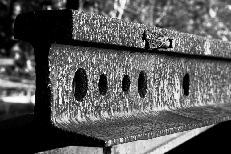 Photo of Old rail sits on a flatcar waiting to be installed