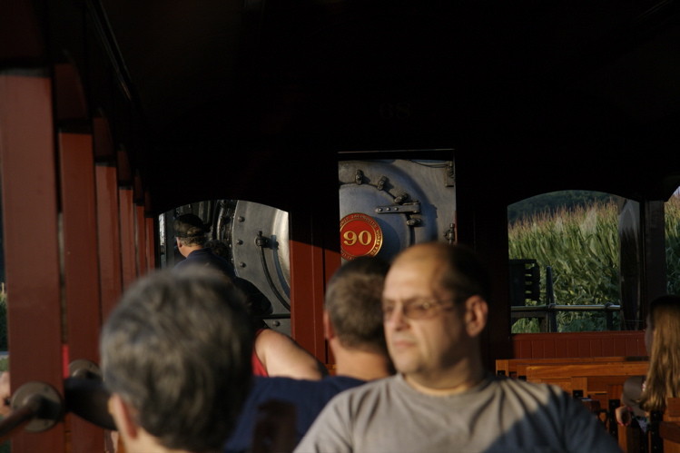 Photo of Strasburg #90 peeks out from behind passengers on its train