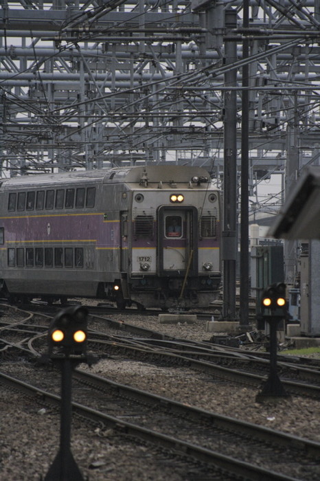 Photo of Two signals stare idly ahead as a commuter rail train arrives at South Station