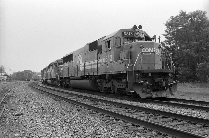 Photo of CMRR dump cars visible to left Of Conrail Freight 1988