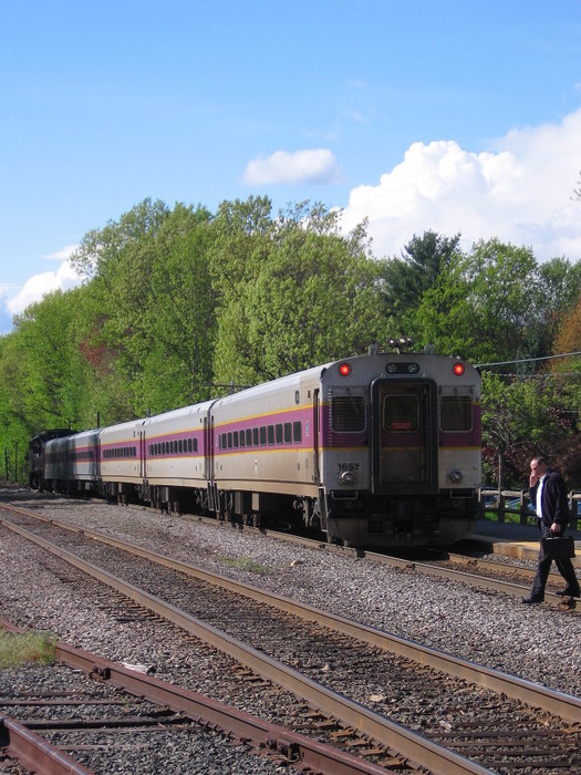Photo of A commuter crosses the tracks as the train departs