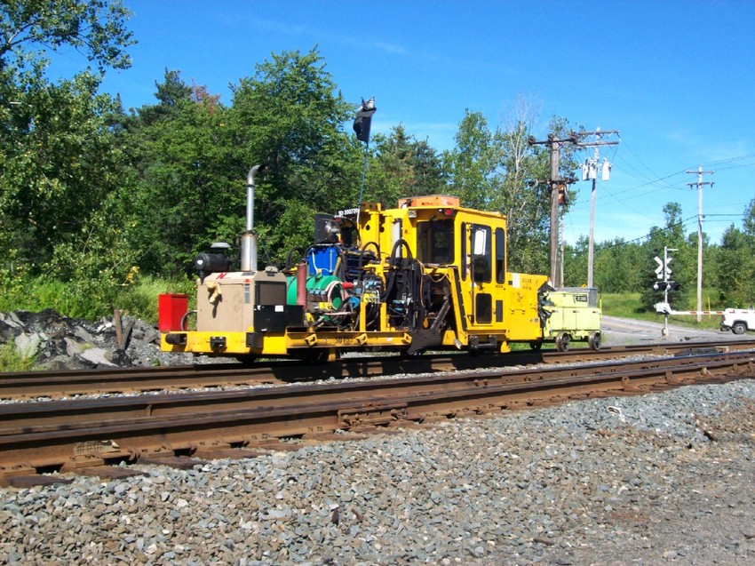 Photo of A huge parade of M.O.W equip. prepares to tie down on a siding east of CP 382.