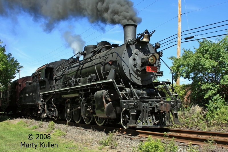 Photo of N Y S & W 2-8-2 #142 'storms' past the cornrows.