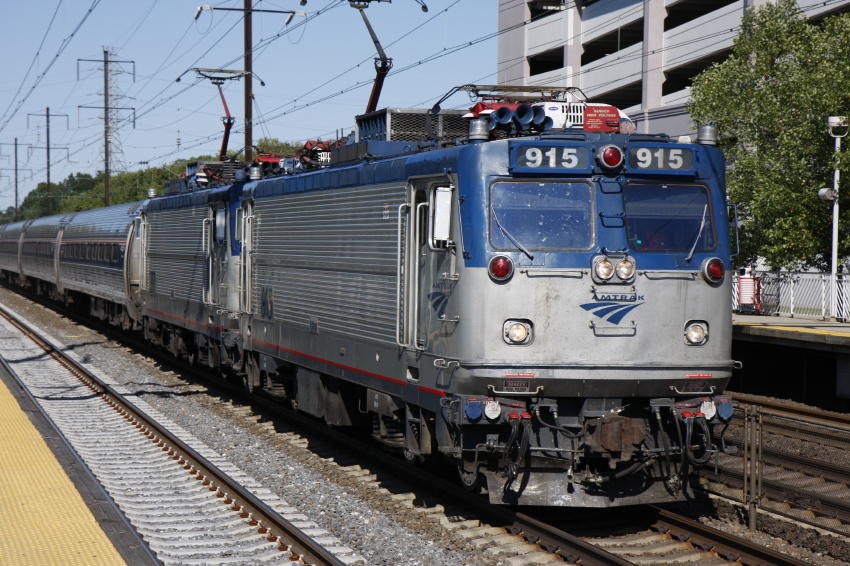 Photo of a pair of Amtrak AEM-&'s blasting through Hamilton NJ Station