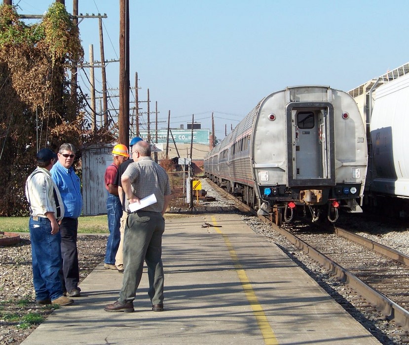 Photo of Amtrak employees gather around the remaining cars in Huntington, WV.
