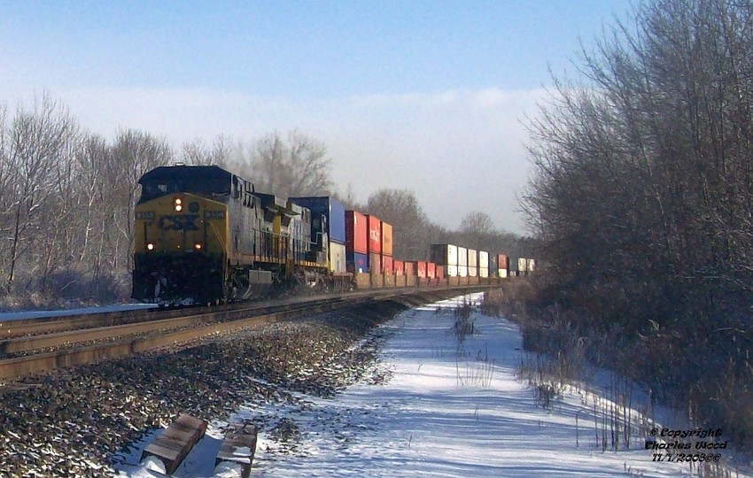Photo of CSX Q161 rolls out of Churchville ny kicking up snow with CSX 355 leading.