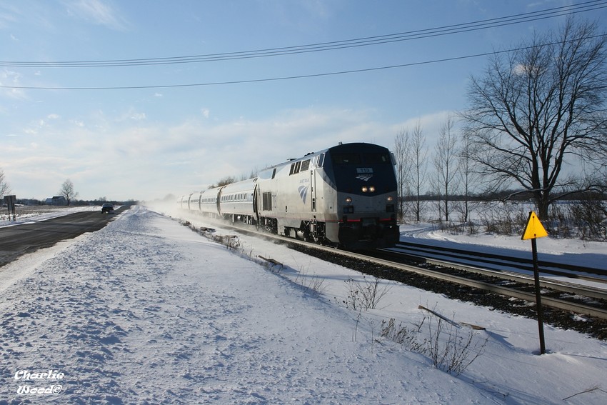 Photo of AMTK 286 whips up snow as it rolls into Bergen ny with AMTK 713 leading.