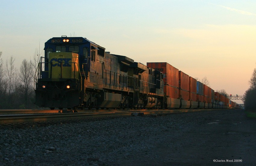 Photo of CSX Q164 is being lead by 7526, a nice standard cab at sunset in Churchville ny.