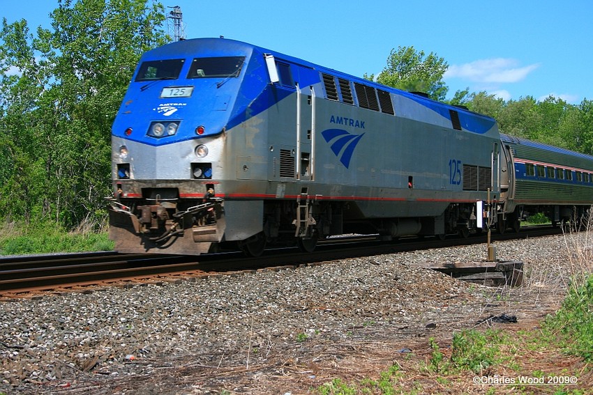 Photo of AMTK WB Maple leaf 63 zooms past the Batavia ny Hotbox detector.
