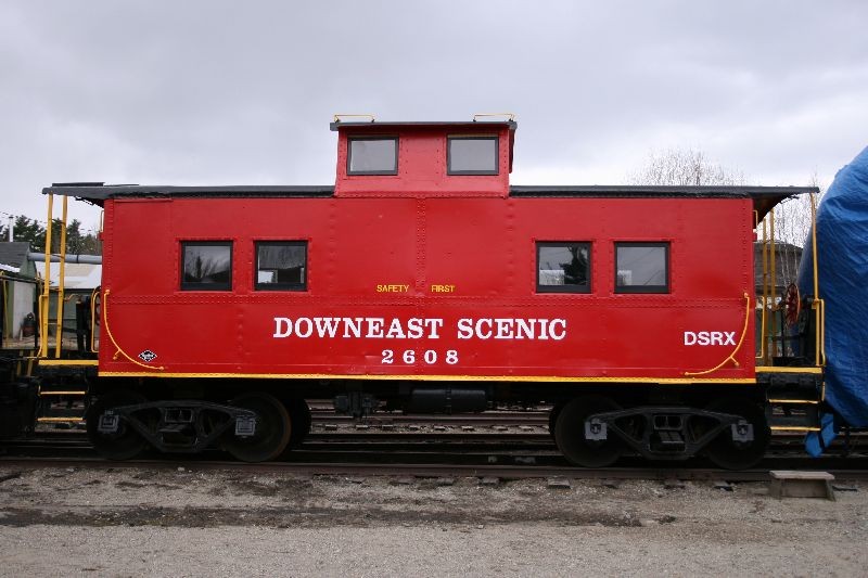 Photo of A bright red caboose.