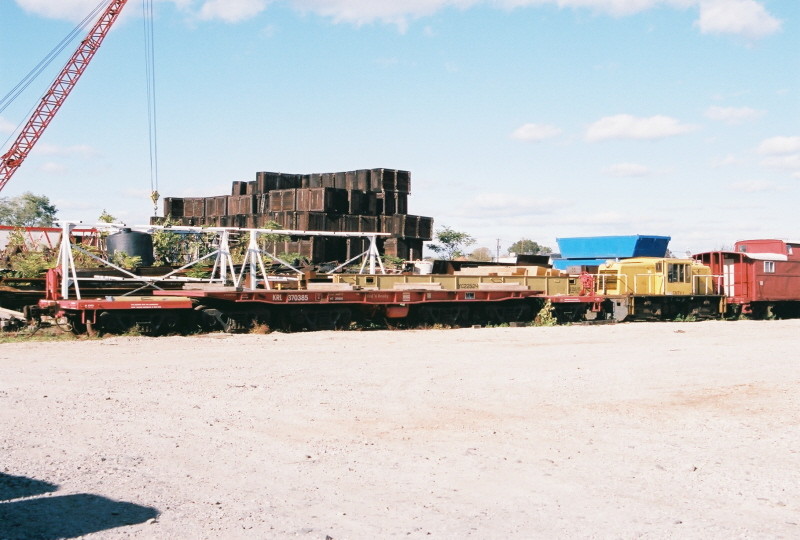 Photo of Construction & Marine Equipment Co. Inc; shd flatcar, GE 35 Tonner & PRR caboose