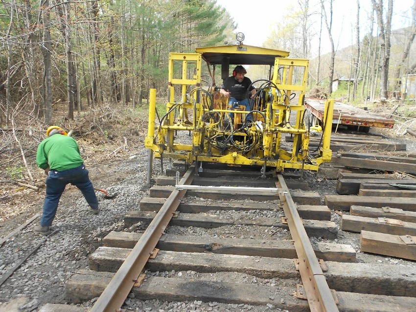 Photo of Tamping the new switch at MP 24.75