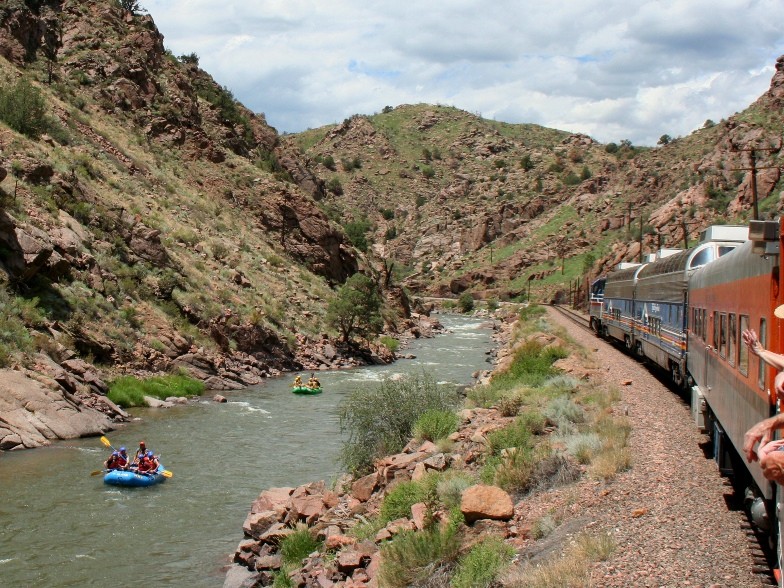 Photo of Rafters pass the Royal Gorge train.