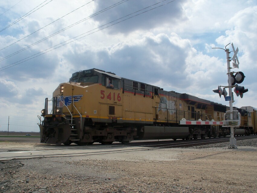 Photo of A Union Pacific Train Crossing Dirt Road