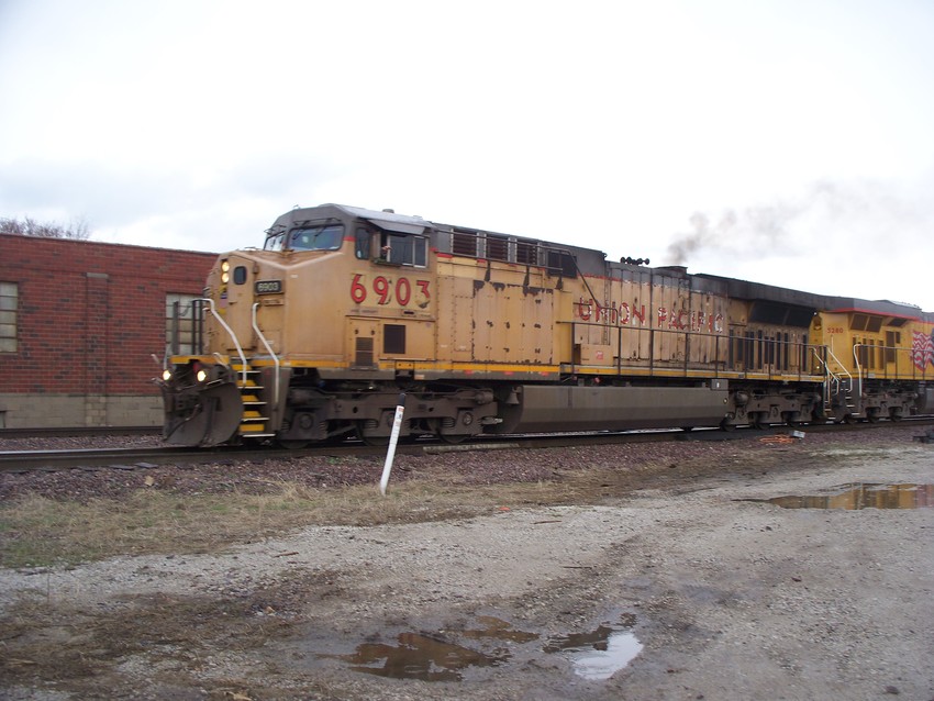 Photo of A  UP grain train departs Hull Ave. Yard